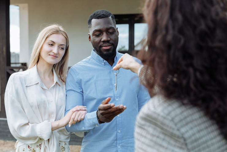 Landlord Handing Keys to New Tenants